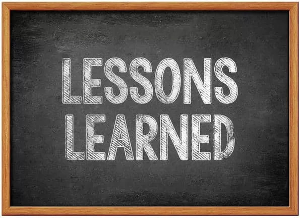 A chalkboard with the words "Lessons Learned" written in uppercase