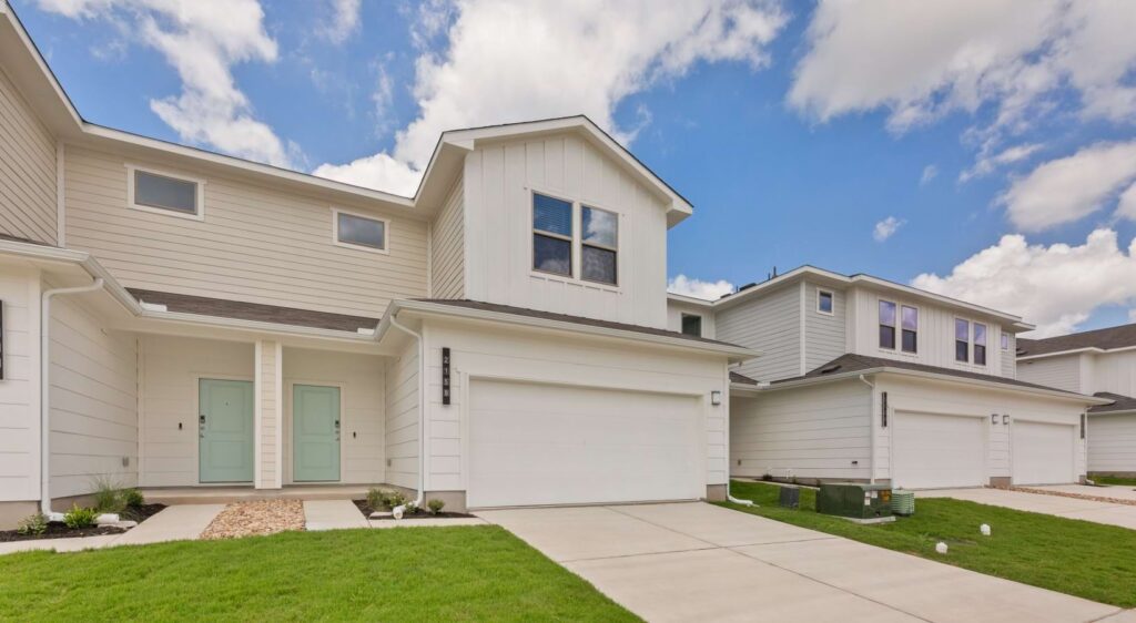 A white house with a driveway of the Wonderyard Residences property.